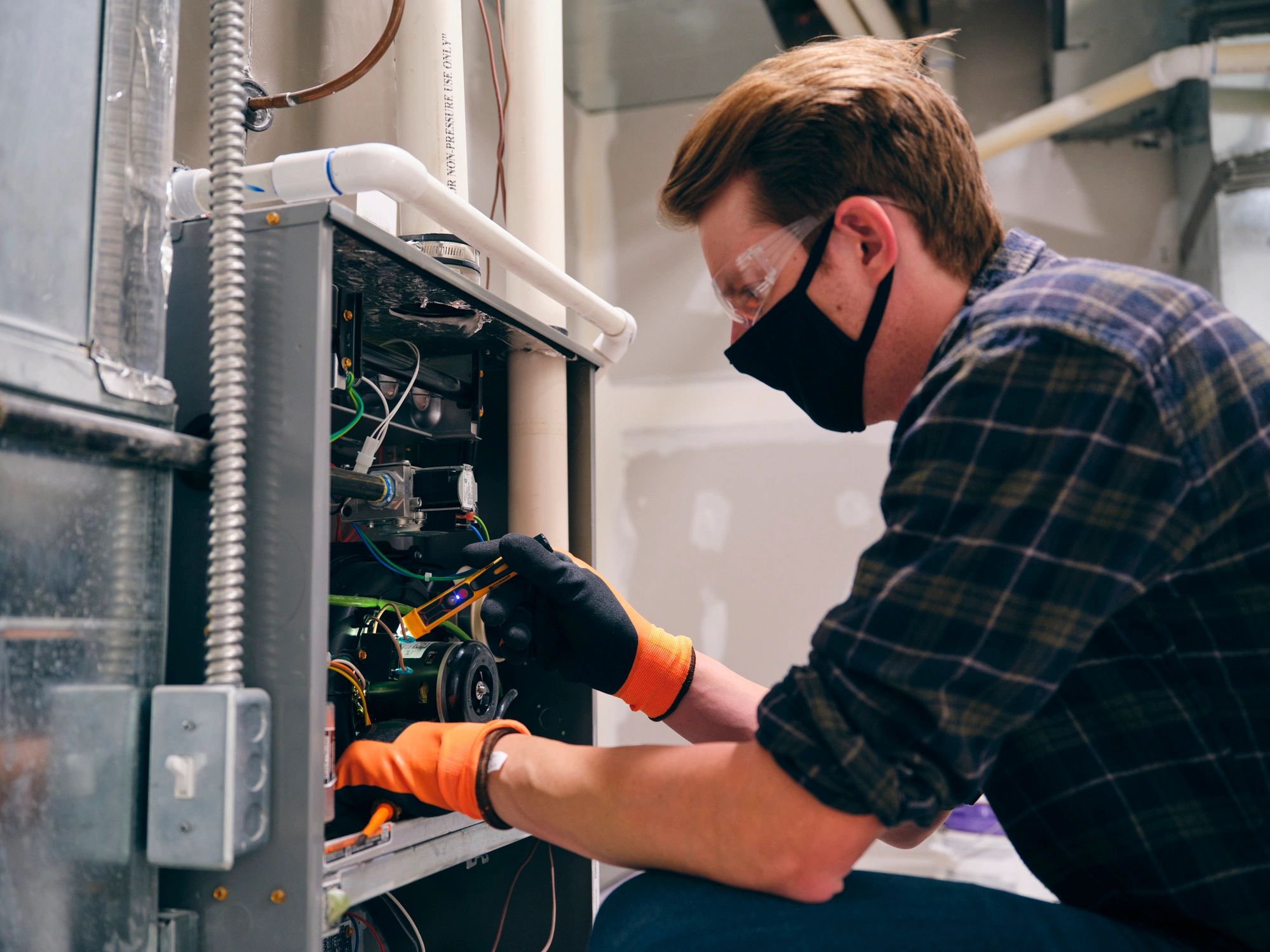 HVAC technician working indoors on a home system