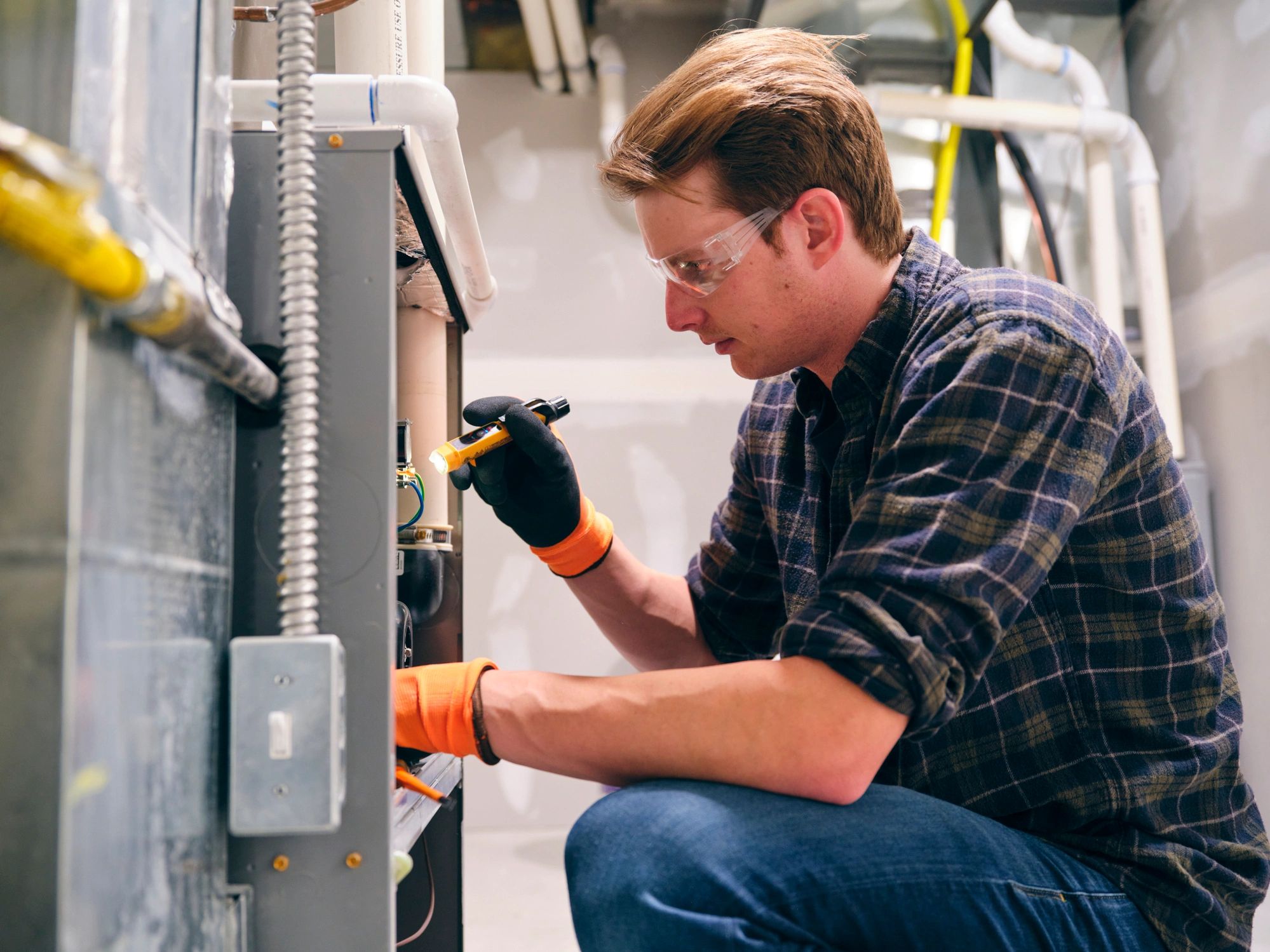 HVAC technician working on a home furnace system
