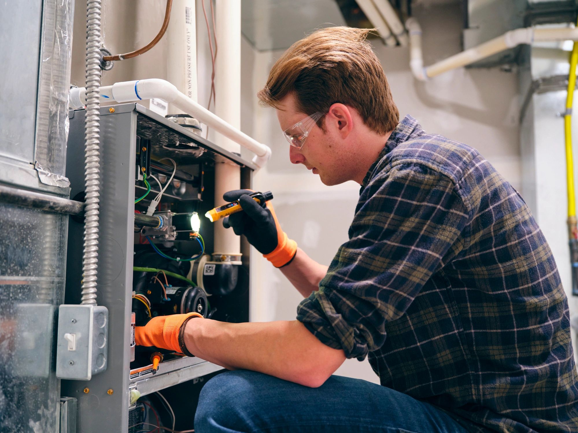 HVAC technician working on a residential furnace
