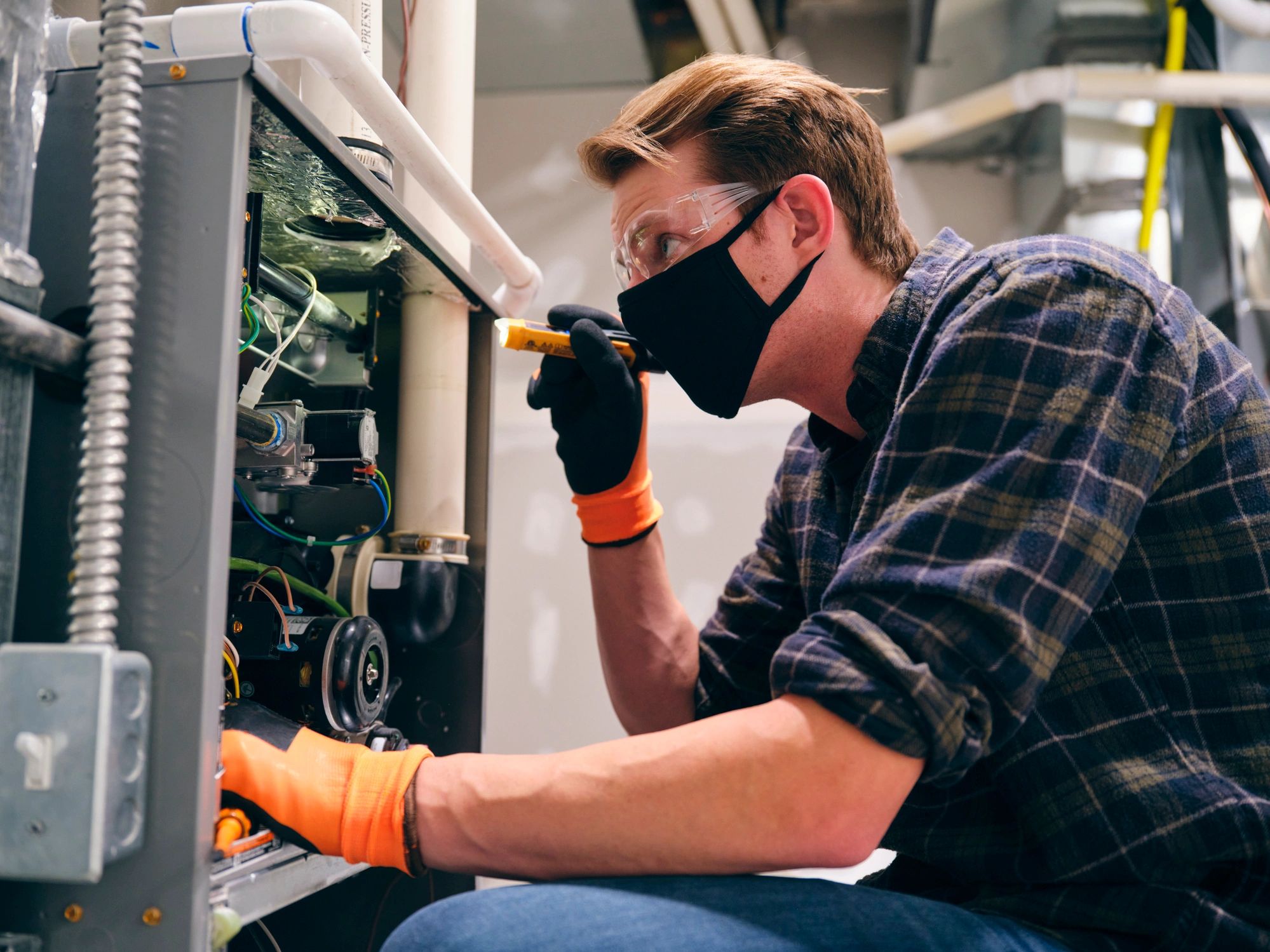 Technician performing HVAC service in a home