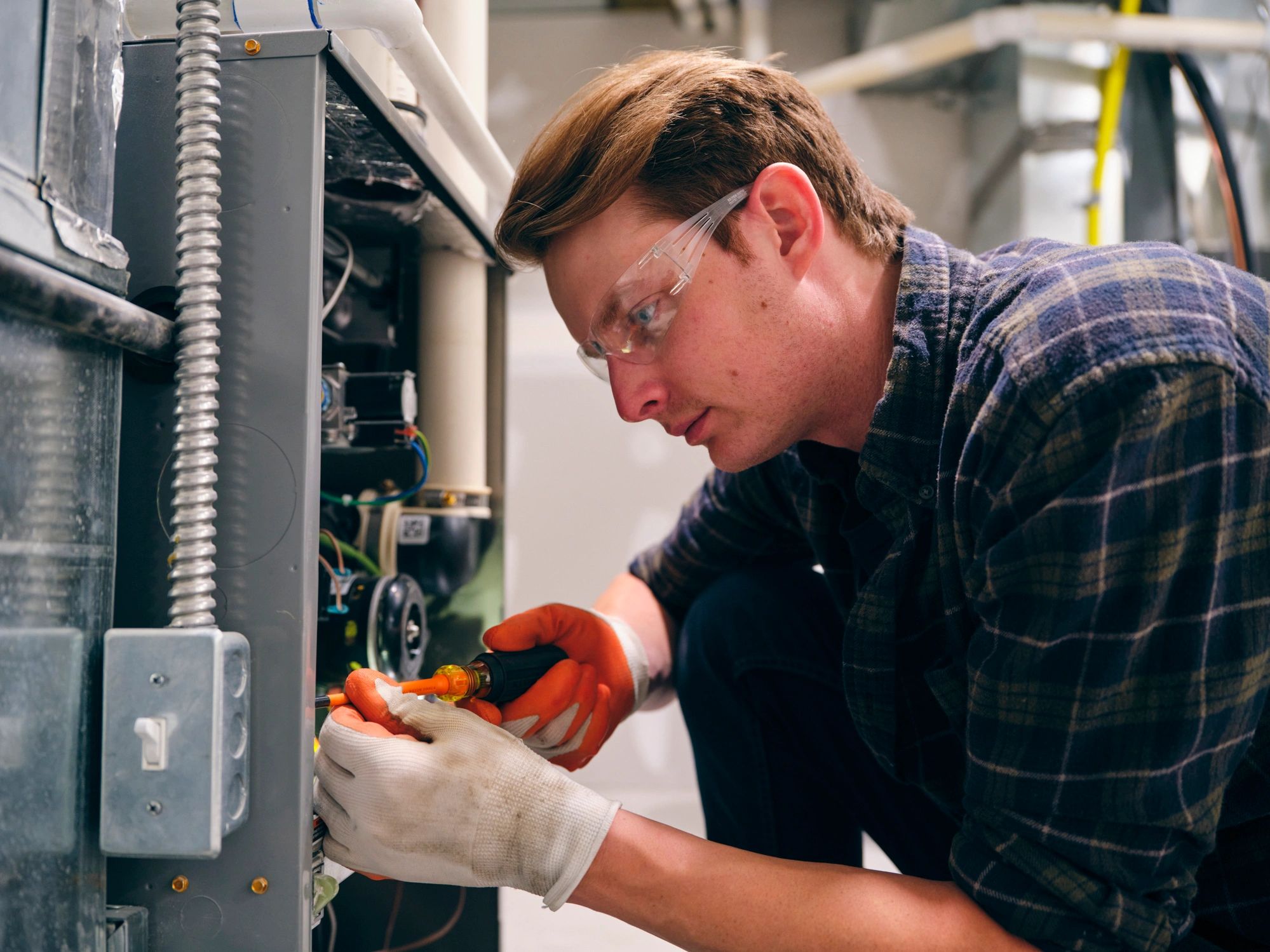 HVAC technician servicing a furnace
