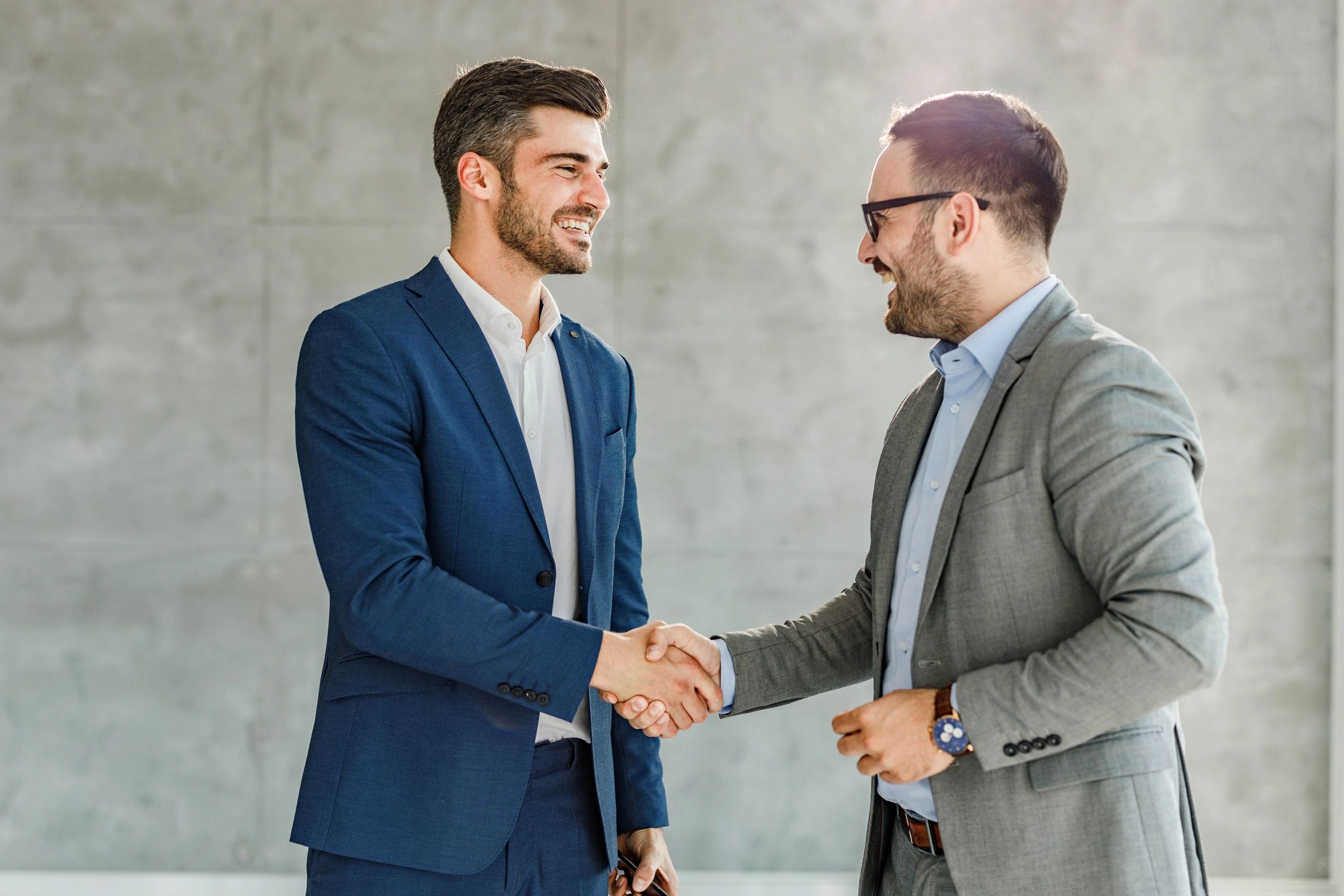 Business partners shaking hands after reaching an agreement.