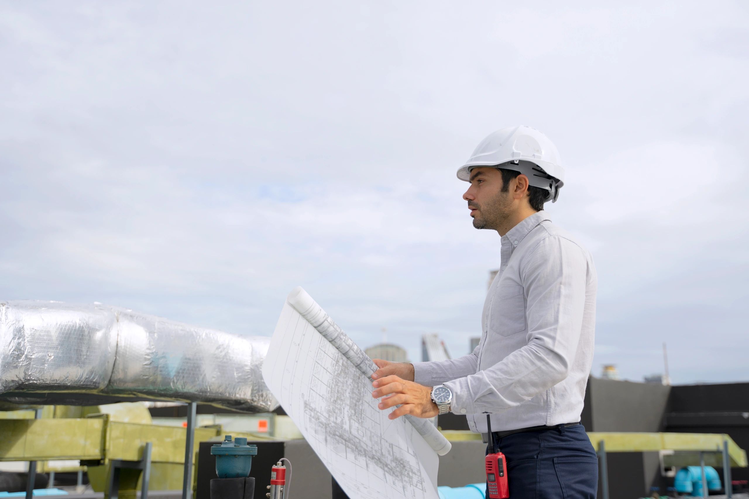 Technician working on a commercial rooftop HVAC unit