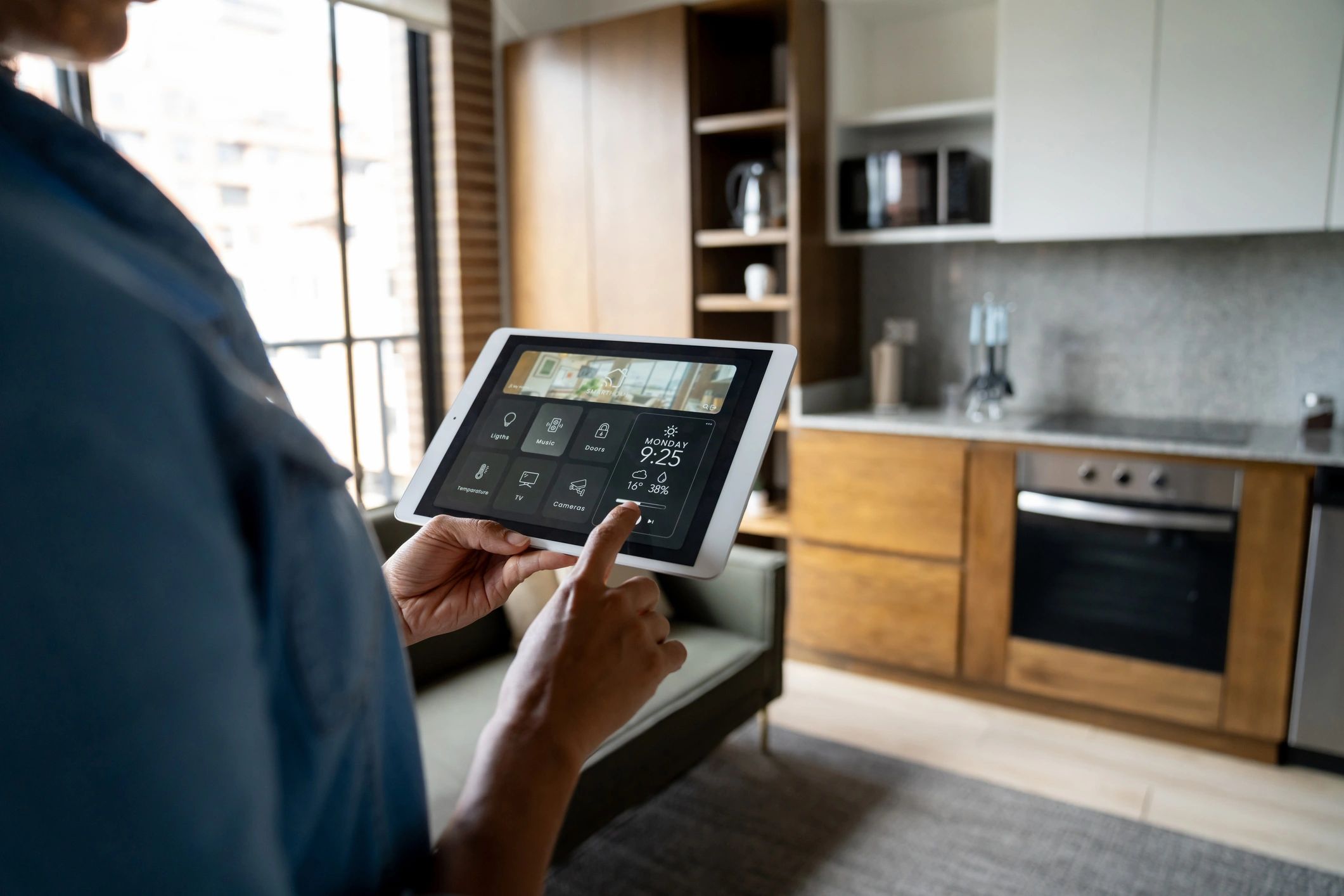 Homeowner using a tablet to control smart thermostat settings